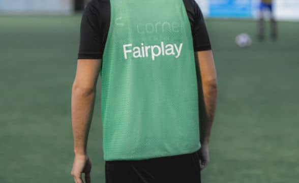 A man in green soccer shirt that says Fairplay