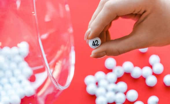 A small lottery ball against a backdrop of more lottery balls.