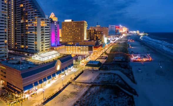 The Atlantic City coast line with buildings all lit up at night.