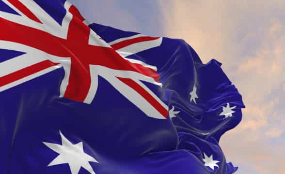 Australian national flag waving in the wind at dawn.