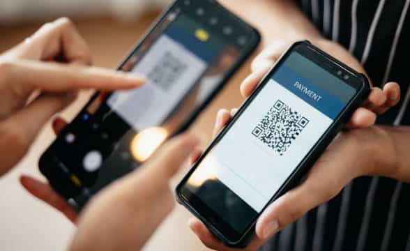 Cashless paymnet options and a QR code being scanned.