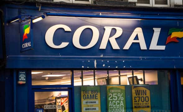 A Coral sports betting shop in the United Kingdom during the evening.