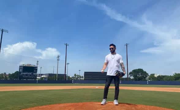 The famous baseball analyst Jared Carrabis is in a baseball stadium on the pitcher's mound.