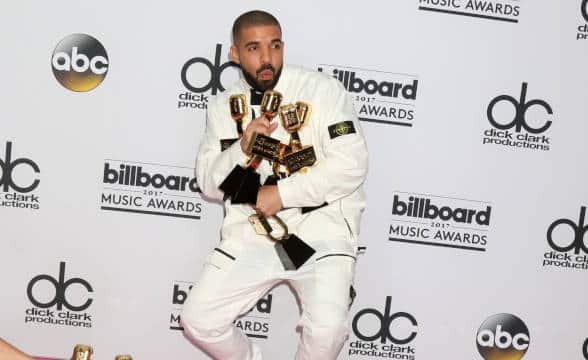 Drake hugging his awards at Music Awards.