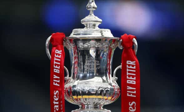 The FA Cup with Liverpool's strips on top.