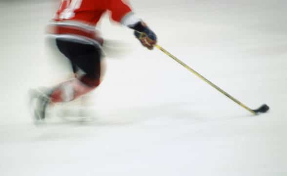 A hockey player in blur.