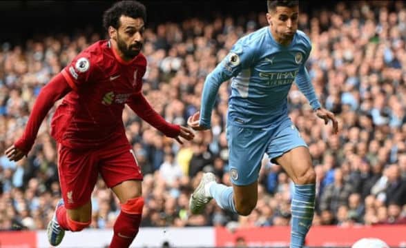 A Liverpool player contesting a Manchester City player in the April 2022 game that finished 2-2.