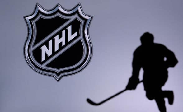 A National Hockey League player's silhouette against the NHL's logo.