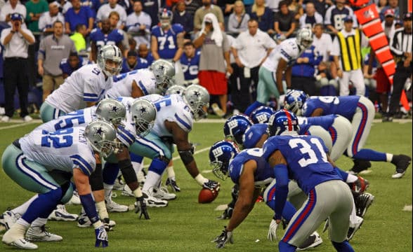 NFL players preparing for a round to start.