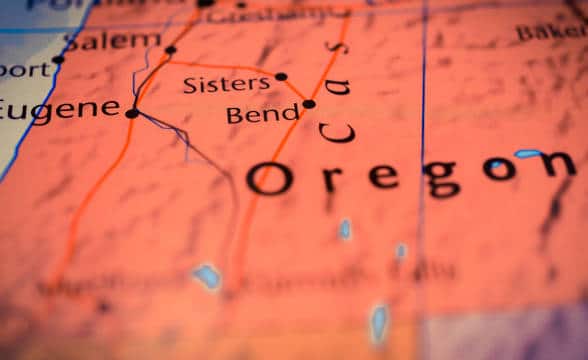 A map of Oregon with the state being painted in red for contrast.