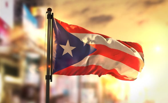 The Puerto Rican flag against a very bright background.