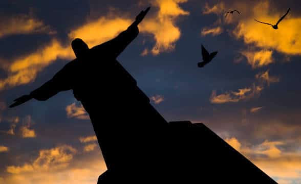 Christ the Redeemer statue in Rio de Janeiro, Brazil, photographed from below and in the dusk.