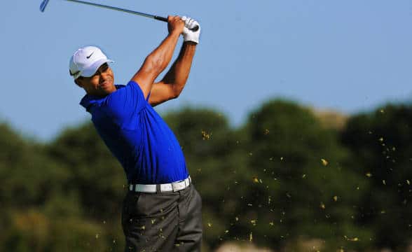 Tiger Woods taking a swing at the golf course.