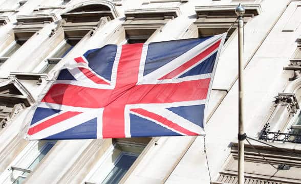 A UK flag flying on a building.