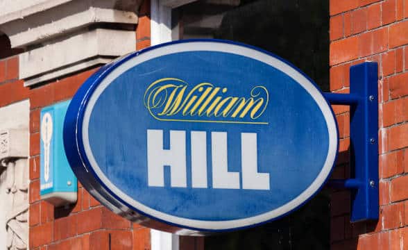 A WIlliam Hill sign somewhere in Britain placed on a building.