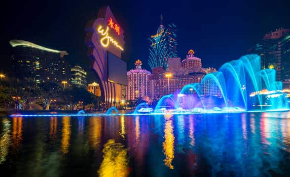 The Wynn Macau casino during the night with the waterfront visible.