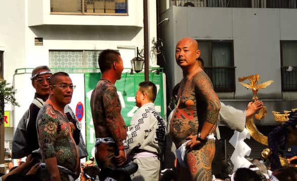 Almost naked members of Yakuza with tattooes.