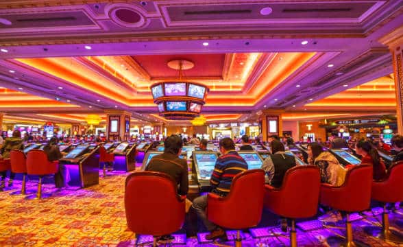 A Macau casino floor with people gaming.