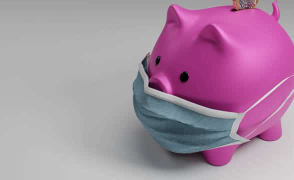 A Pigglet pink bank wearing a surgical mask against COVID-19.