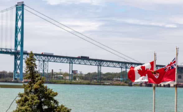 Canadian and Ontario flags flapping in the air in Windsor, Canada.