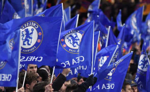 Chelsea FC fans waving flags.