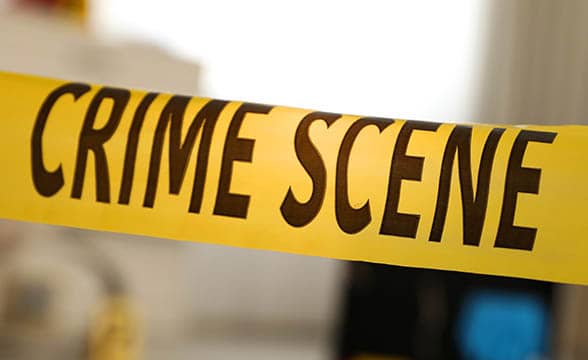 A yellow ribbon marks a crime scene