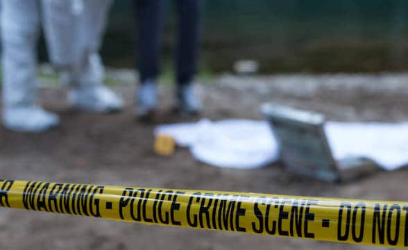 A yellow ribbon around a crime scene.