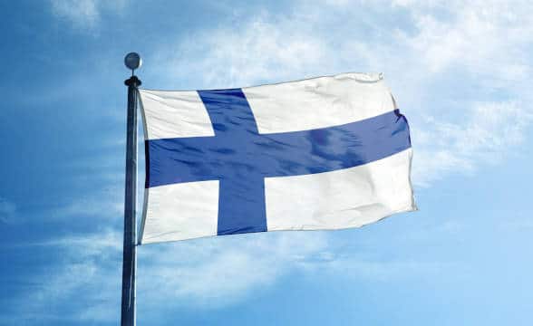 The Finnish national flag flying on a pole.