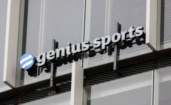 Genius Sports' official logo on a building.