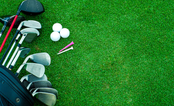 Golf paraphernalia on a green-felted surface.