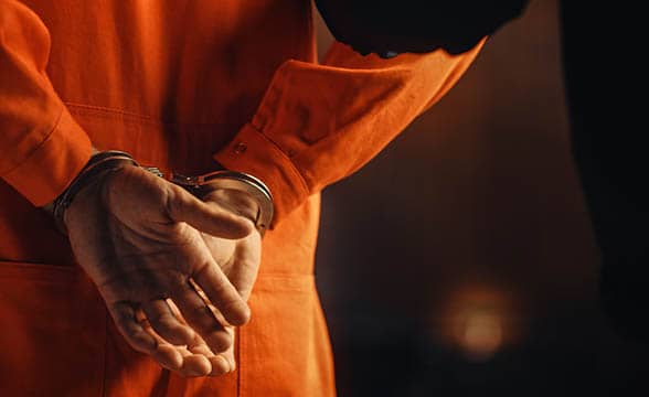 A handcuffed prisoner