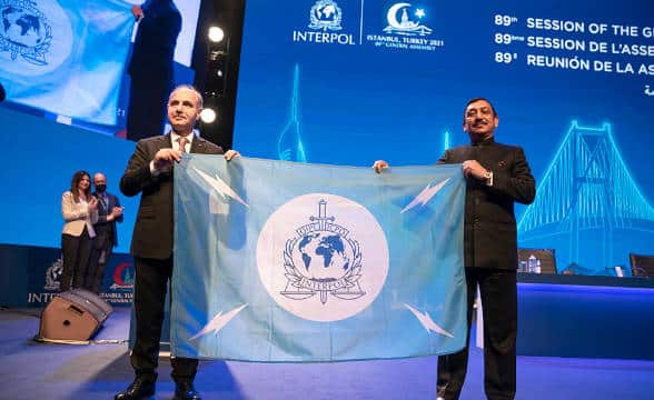 Two officials at an official Interpol ceremony.