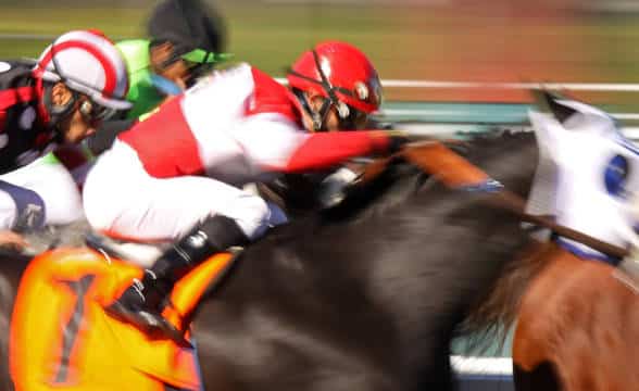 Jockeys in a blur as they race through the track.