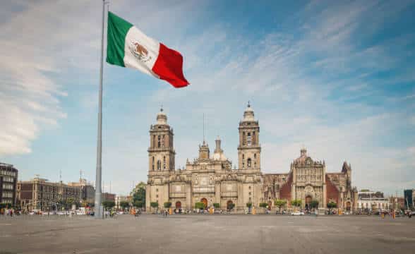 The Zocalo Square in Mexico with the national flag on a pole.