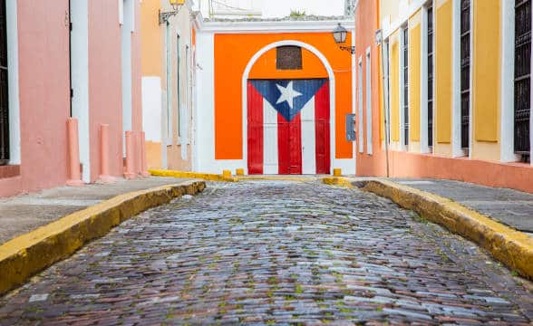 Puerto Rico empty street and the national flag paintedon a door.