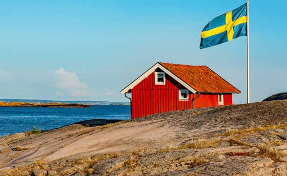 Swedish flag and a house on an island in Sweden.