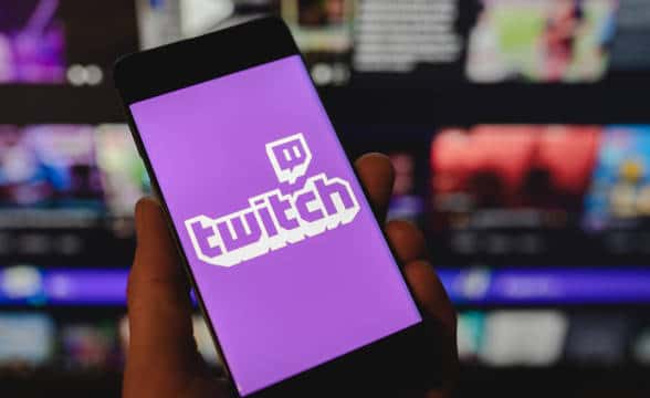 Twitch loaded on a smartphone that is held by a person.