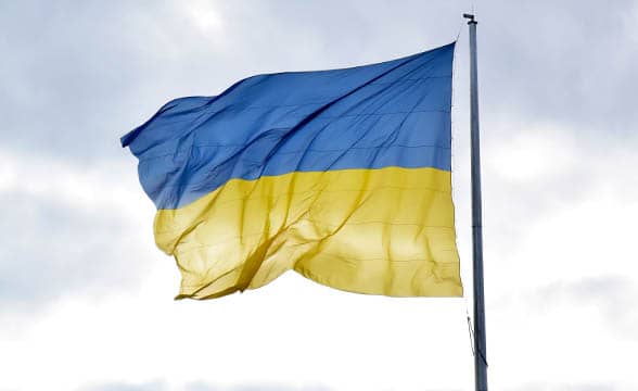 Ukraine's flag on a stormy sky