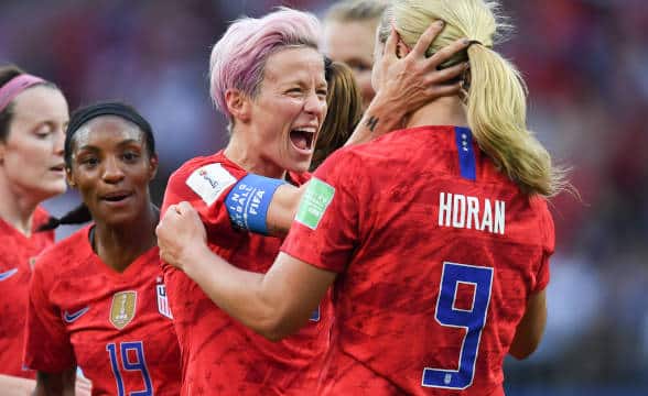 The USA women's soccer team rejoicing after a goal.