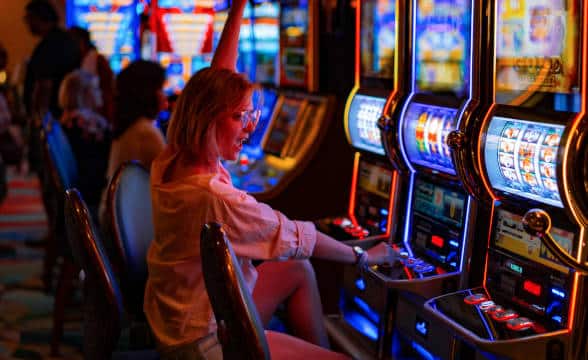 A girl playing physical slots on a casino floor in the US.