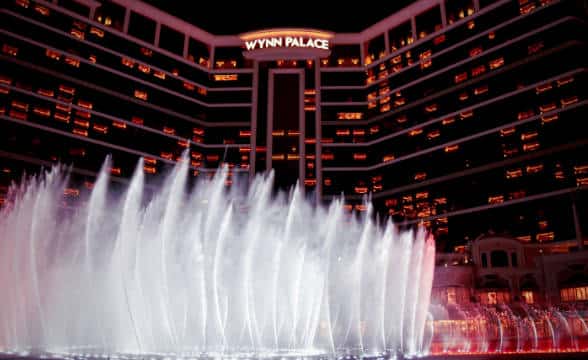 The Wynn Palace Casino in Macau shot during the night with the fountain squriting water sprays.