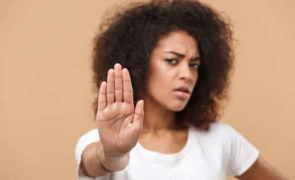 A woman making a stop sign with her palm.