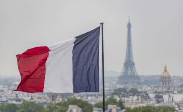 The French flag with the Eiffel Towel behind.