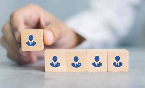 Cubes with people on them standing for appointment in a company.