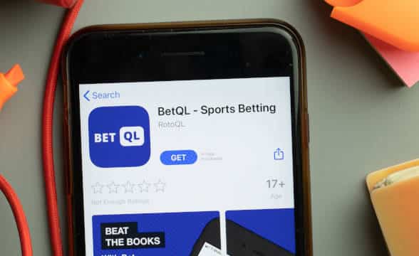 The BetQL sports betting app loaded on a smartphone waiting to be downloaded.