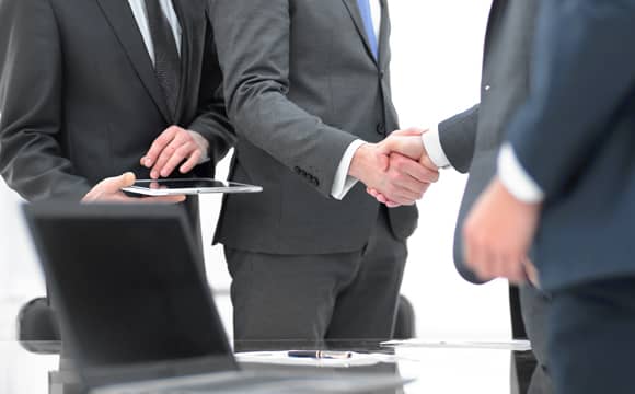 Business men closing the deal by shaking hands