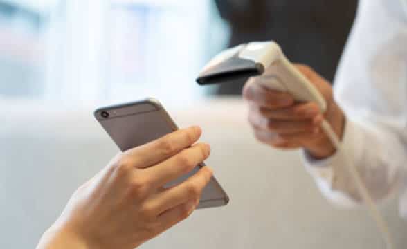 A person paying with their smartphone.