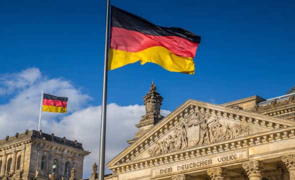 Germany's national flag flying over the Bundestag.