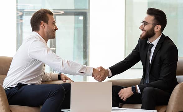 Two businessmen shake hands