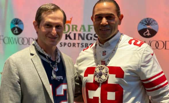 Jason Robins with an NFL player at the Connecticut DraftKings sportsbook.